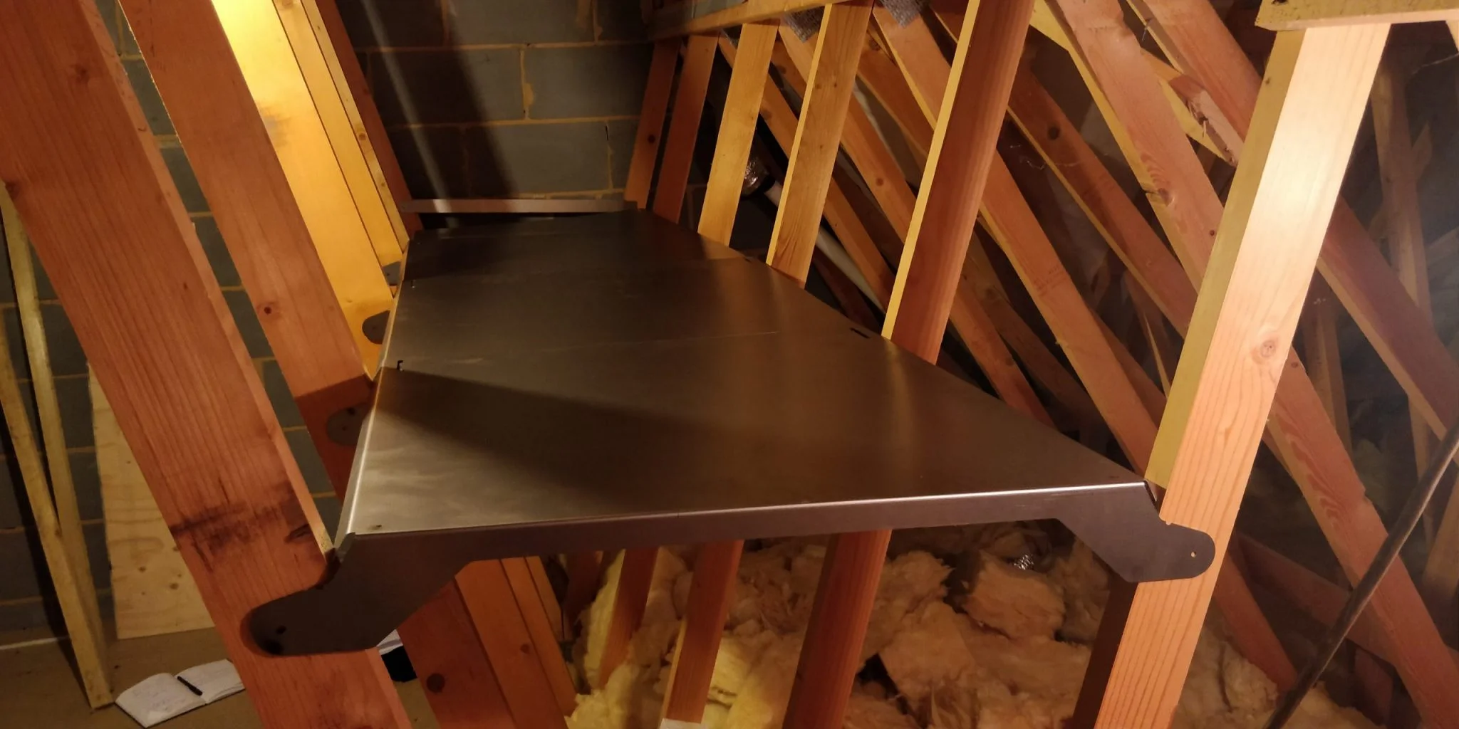 A closeup of a metal shelve added in an attic for extra storage space.