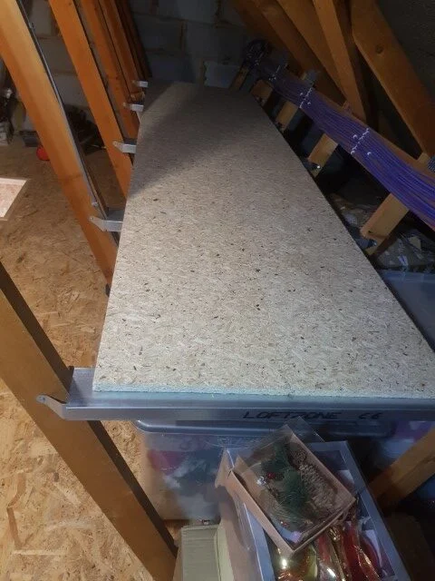 wooden attic shelf being installed