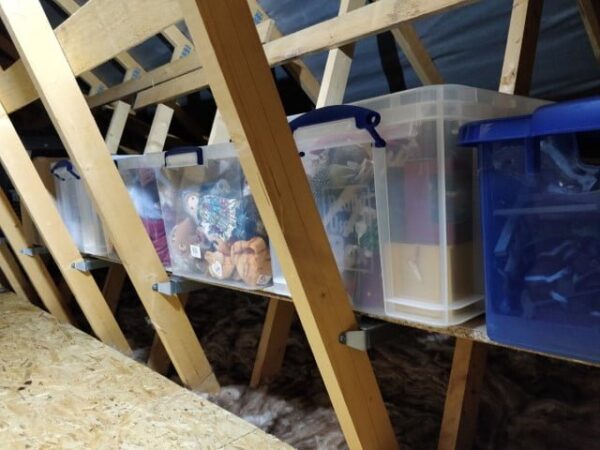 storage boxes stored on wooden attic shelving