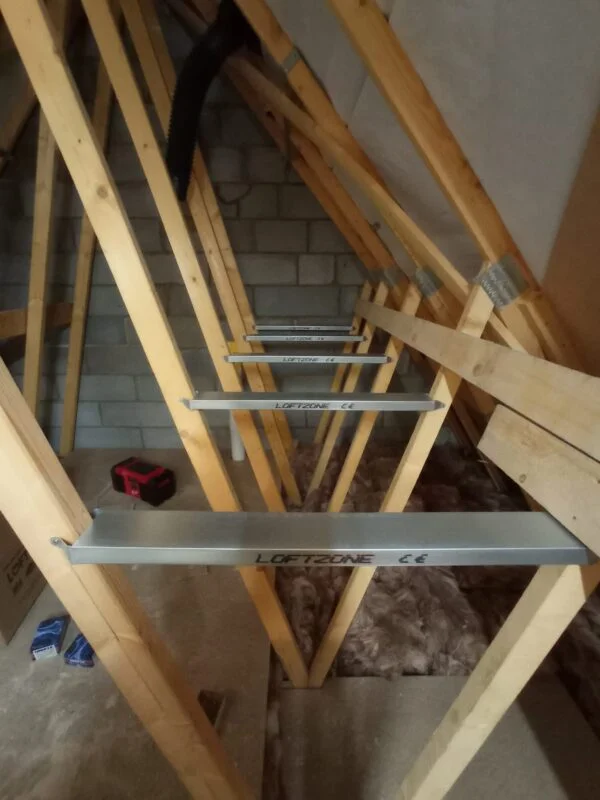 An attic with brackets fitted between ceiling joists.