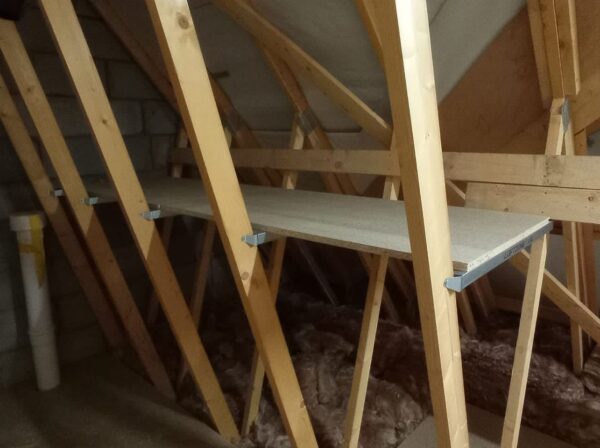 front view of wooden attic shelf installed in an attic