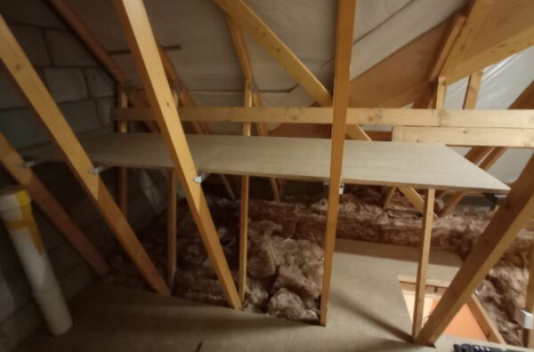 full view of a wooden attic shelf installed in attic beams