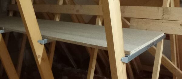 zoomed in front view of wooden attic shelf installed in an attic