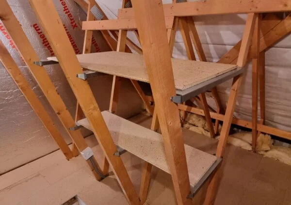 Wooden shelves fitted between ceiling joists.